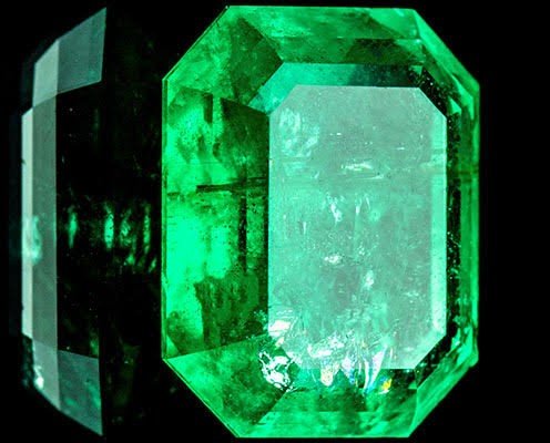Emerald-cut green gemstone on black