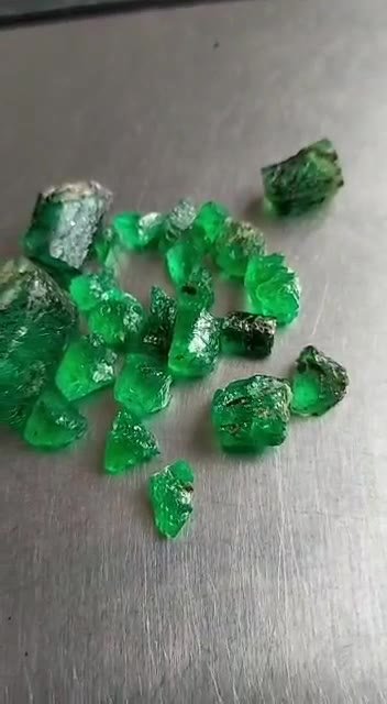 Rough hexagonal emerald crystals on white