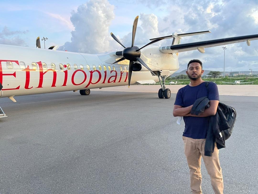 Charis Export team member beside an Ethiopian Airlines aircraft