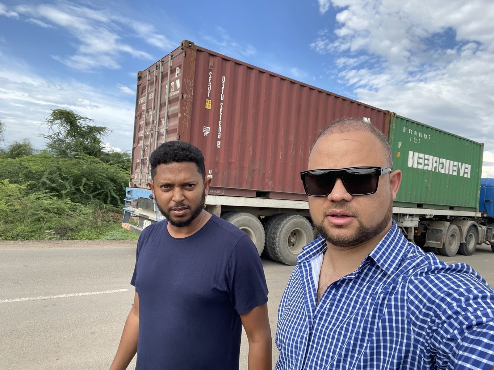 Charis Export team beside a loaded shipping container truck